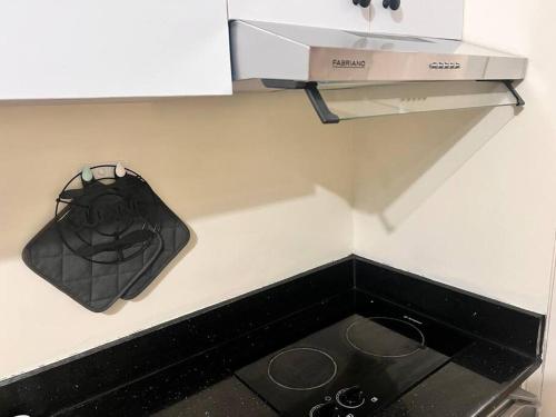 a black bag is hanging on a kitchen counter at Comfortable 2bedroom with pool Avida Tower, IT Park in Tabok