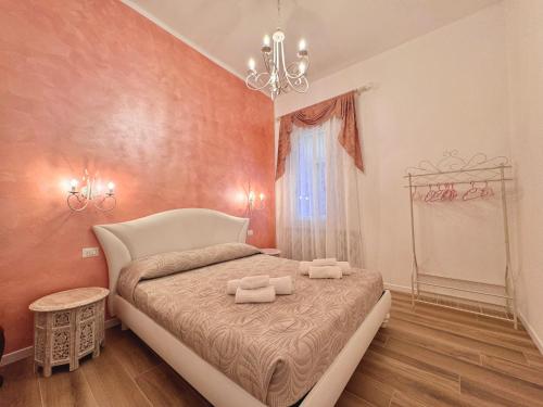 a bedroom with a bed with two towels on it at Airoldi Palace Apartment in Chioggia