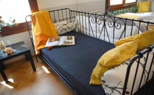 a room with a bed with a book on it at Estudio La Tienda de Adanero in Adanero