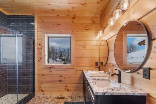 un bagno con lavandino e specchio di Big Sky Cabin at Monteagle a Banner Elk