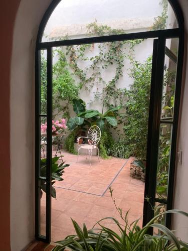 an open door to a patio with a chair at Patios del Agua in El Puerto de Santa María