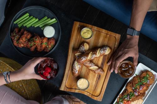 a group of people standing around a table with food at Galt House Hotel, A Trademark Collection Hotel in Louisville