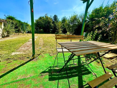 a picnic table and a bench in a park at Vacation House in Quiet Village in Congerville