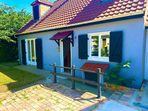 a blue house with a bench in front of it at Vacation House in Quiet Village in Congerville