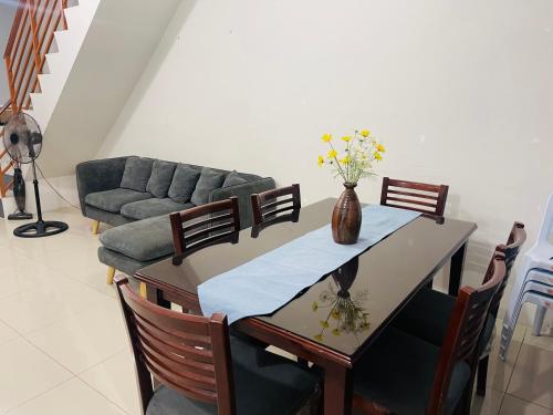 a living room with a table and a couch at Haralds Air B&B in Casamira Naga in San Fernando
