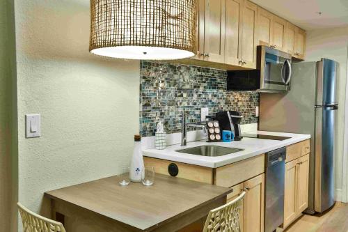 a kitchen with a sink and a counter top at Princess Royale Oceanfront Resort in Ocean City