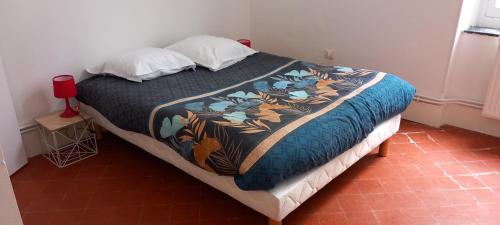 - une chambre avec un lit et une couverture colorée dans l'établissement Appartement Haussmannien 5 personnes ChapeauRouge Hôtel de ville Béziers centre historique coeur de l'Hérault capitale occitanie, à Béziers