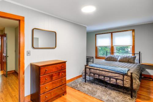 a bedroom with a bed and a dresser and a mirror at Charming Damascus Retreat with Deck and Creek Views! in Damascus