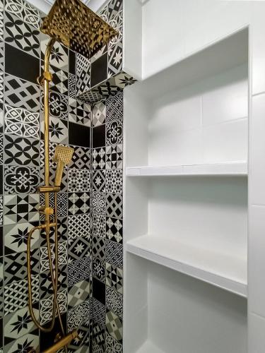 a bathroom with black and white tiles on the wall at Sea View La Mata Apartment in La Mata
