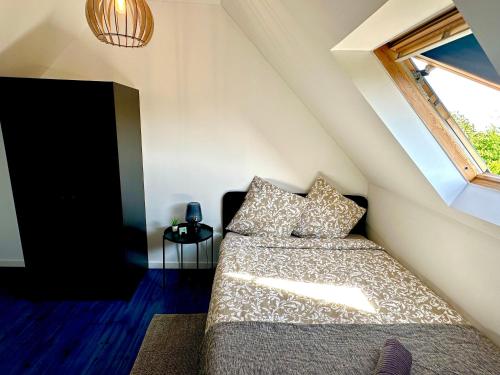 a bedroom with a bed and a window at Vacation House in Quiet Village in Congerville