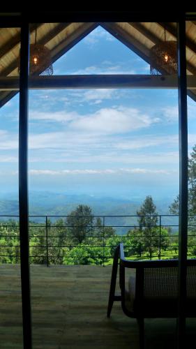 a view from a window of a porch with a bench at Vantage hills Haputale in Haputale