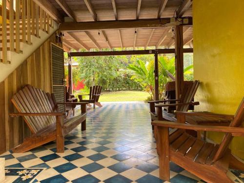 a porch with rocking chairs and a table at Casa Olingo in Cocles