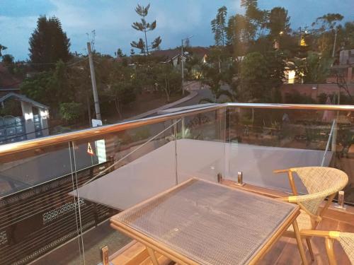 a table and a chair on a balcony at Ineza Apartment in Kigali
