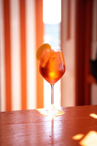a drink in a glass with a lime on a table at Hotel Villa Maria in Ischia