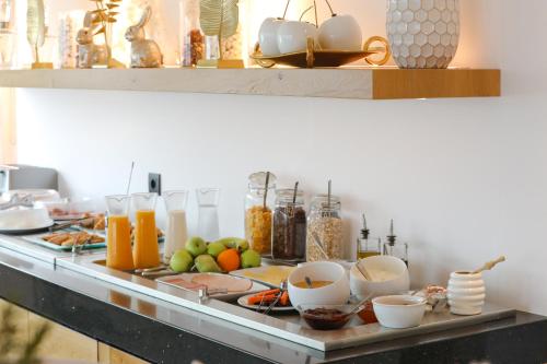 a buffet with food and drinks on a table at Ibiscus Boutique in Mýkonos City