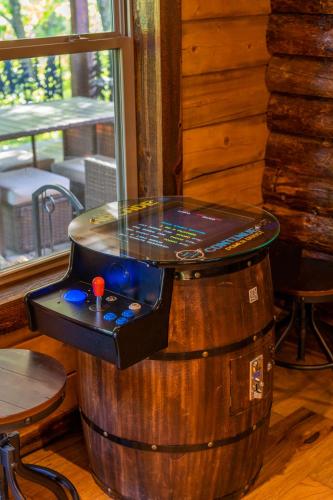 a game table on top of a wooden barrel at River Lodge Escape with Hot Tub in Glenwood