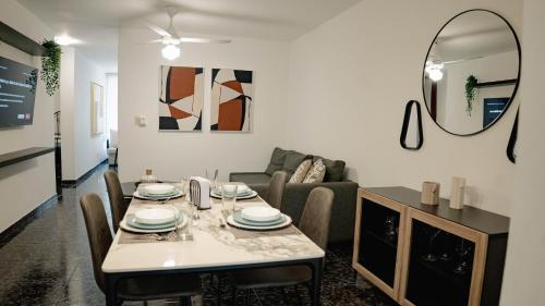 a living room with a table and a couch at Residenciales H1 & H2 - Breakfast & Room Service - Airport close in Santiago de los Caballeros