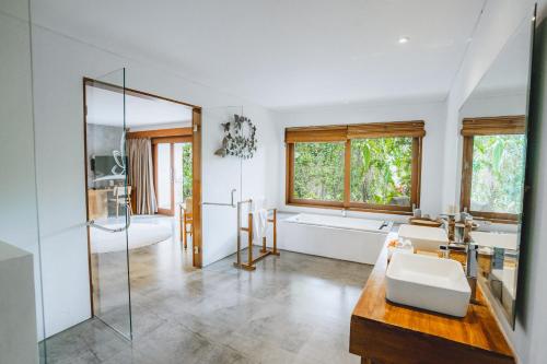 a bathroom with a tub and a sink and a shower at The Hidden Paradise Ubud - CHSE Certified in Ubud