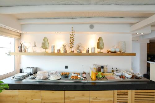 a kitchen with a counter with food on it at Ibiscus Boutique in Mýkonos City