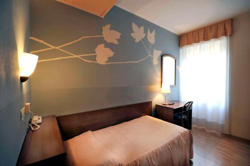 Postel nebo postele na pokoji v ubytování Ai Campi Di Marcello Hotel