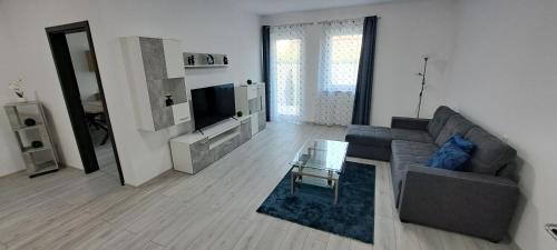 a living room with a couch and a glass table at Haus MaryLu in Knetzersdorf