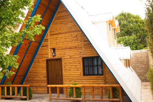 a wooden house with a staircase leading up to it at Cabañas Bungalos las Alazanas in San Antonio de las Alzanas
