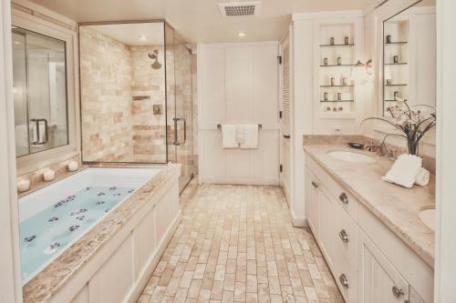 a bathroom with a tub and two sinks and a shower at 3-Bed Villa 315 at Turtle Bay in Kahuku