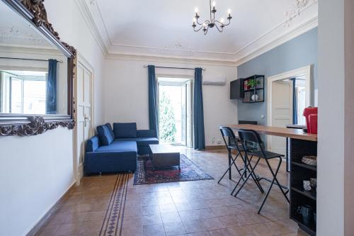 a living room with a blue couch and a table at Frally's dream in Catania