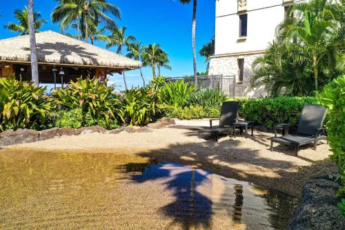 a group of chairs sitting next to a body of water at Ocean Tower 503 at Ko Olina in Kapolei