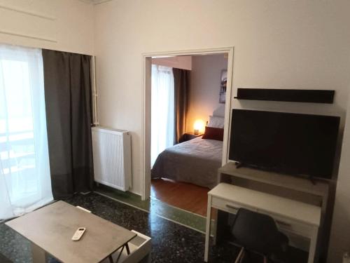 a room with a bed and a tv and a mirror at Thissio Hideaway Suite in Athens