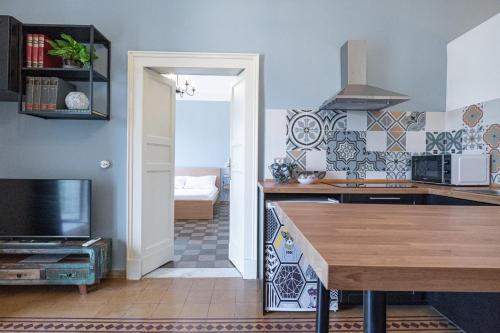 a kitchen with a table and a tv in a room at Frally's dream in Catania
