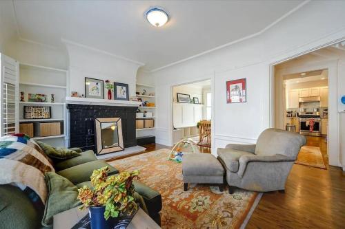 a living room with a couch and a fireplace at Spacious SF Haven - Cozy Bedrooms & Modern Kitchen in San Francisco