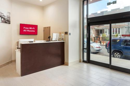 a store with a sign that reads free wifi at rooms at Red Roof Inn PLUS Jamaica, NY - JFK Airport in Jamaica