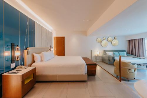 a hotel room with a bed and a desk at Hard Rock Hotel & Casino Punta Cana - All Inclusive in Punta Cana
