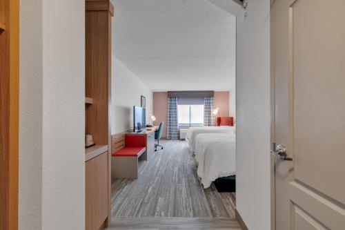 a hotel room with a bed and a television at Hilton Garden Inn Myrtle Beach/Coastal Grand Mall in Myrtle Beach