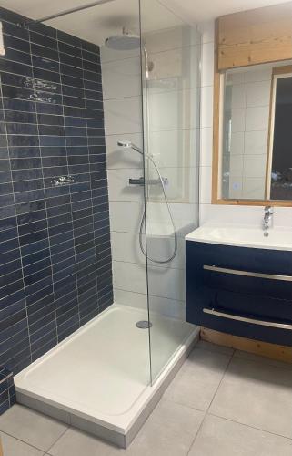 une salle de bain avec une douche en verre et un lavabo dans l'établissement Chalet Olimon, à Saint-Jean-dʼAulps