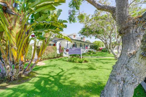 a house with a green yard with a tree at Victorian Carpinteria Apartment Less Than 1 Mi to Beach! in Carpinteria