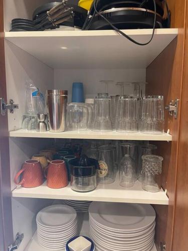 a cabinet filled with dishes and jars and plates at The Escapade - Private hot tub with pool table in Sainte-Lucie-de-Doncaster