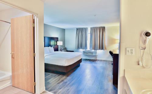 a hotel room with a bed and a bath tub at Baymont by Wyndham Tucson Airport in Tucson