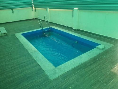 a swimming pool with blue water in a building at ECR 2 Relaxing Modern 3BHK Villa Private Pool in Tirupporūr