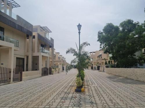 a cobblestone street with a tree in the middle at ECR 2 Relaxing Modern 3BHK Villa Private Pool in Tirupporūr
