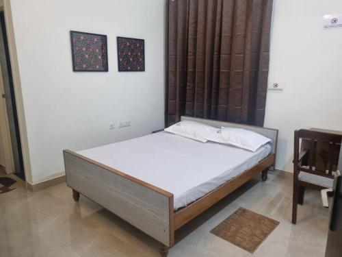 a bedroom with a bed and a chair at ECR 2 Relaxing Modern 3BHK Villa Private Pool in Tirupporūr