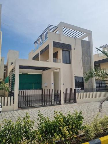 a house with a fence in front of it at ECR 2 Relaxing Modern 3BHK Villa Private Pool in Tirupporūr
