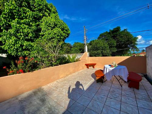 a table and chairs sitting on a patio at Recanto do Cajueiro Garça in Maceió