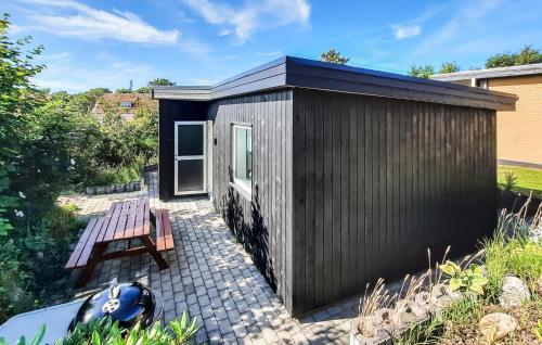 a small shed with a picnic table and a bench at Stunning Apartment In Skagen With Wifi in Skagen