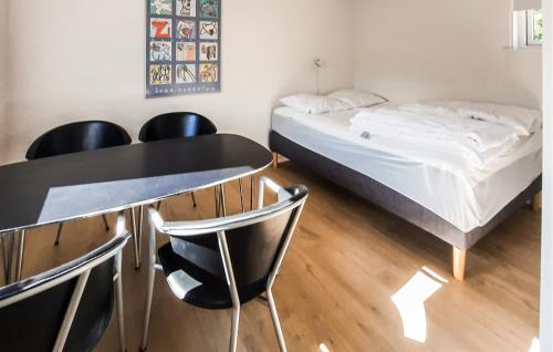 a room with a bed and a table and chairs at Stunning Apartment In Skagen With Wifi in Skagen
