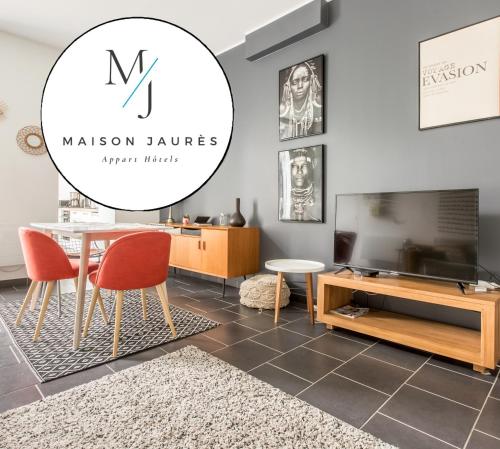 a dining room with a table and a tv at La Maison Jaurès - L'Ethnique in Liévin