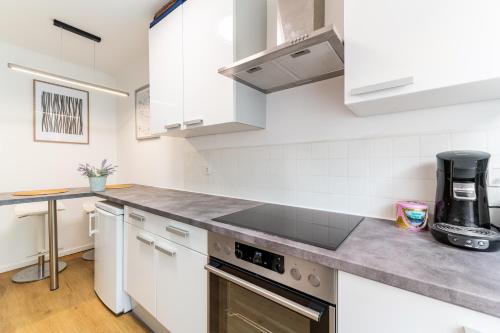 a kitchen with white cabinets and stainless steel appliances at Cozy apartment in Graz-3Guests-free Parking in Graz