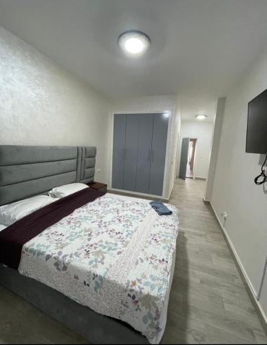a bedroom with a bed with a flowered blanket at Marina AP8 in Saidia 