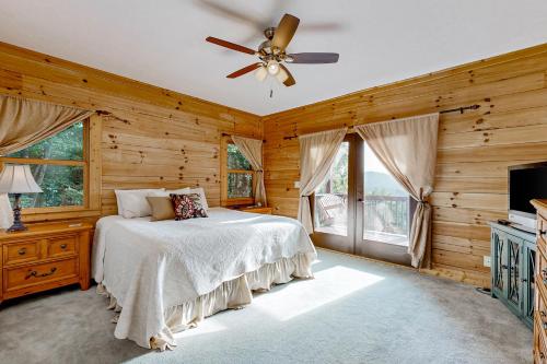 a bedroom with a bed and a ceiling fan at The Glen of Iron Duff in Waynesville